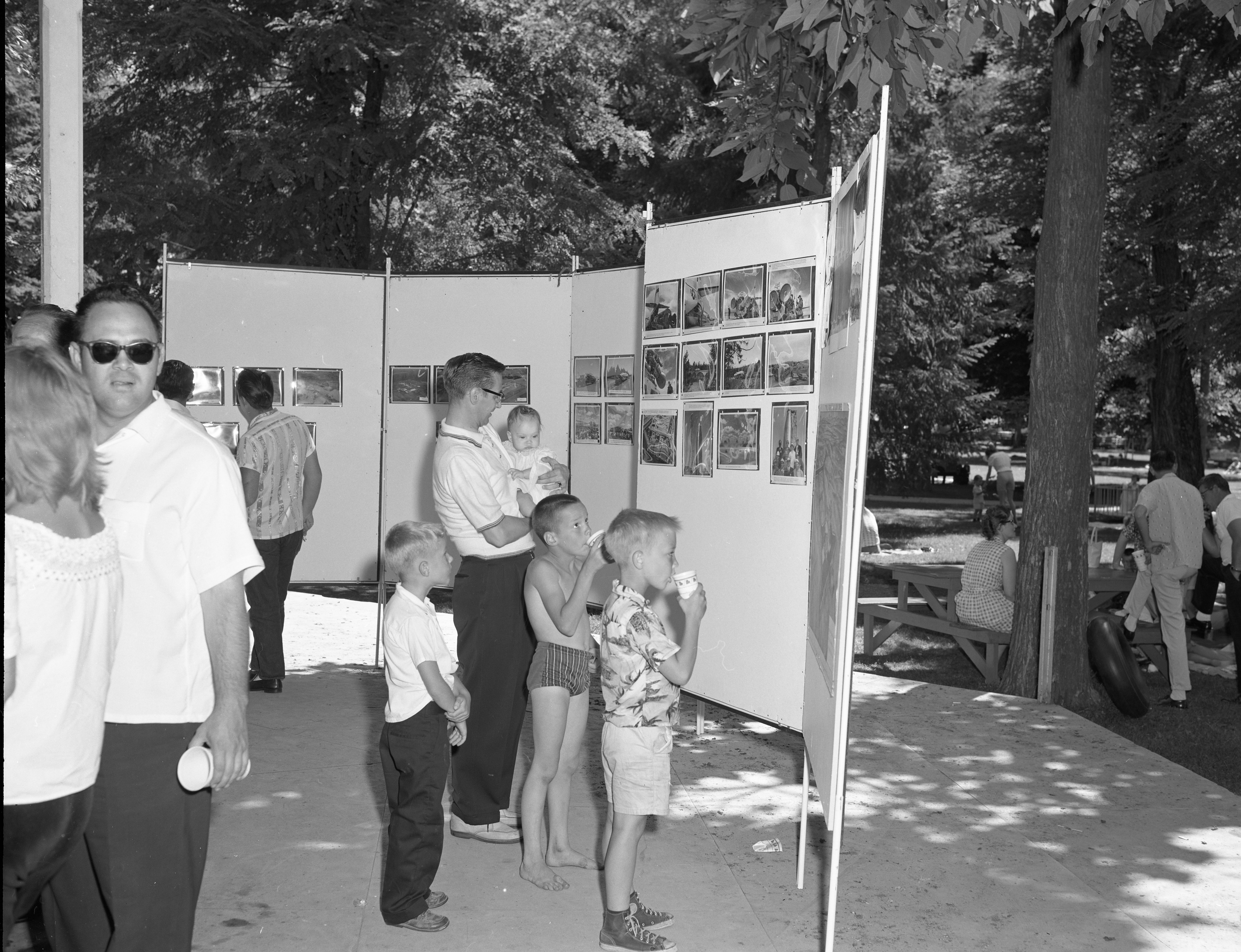 Convair employee showing his family examples of the work completed by Convair Astronautics employees at Fairchild U.S. Air Force Base. 