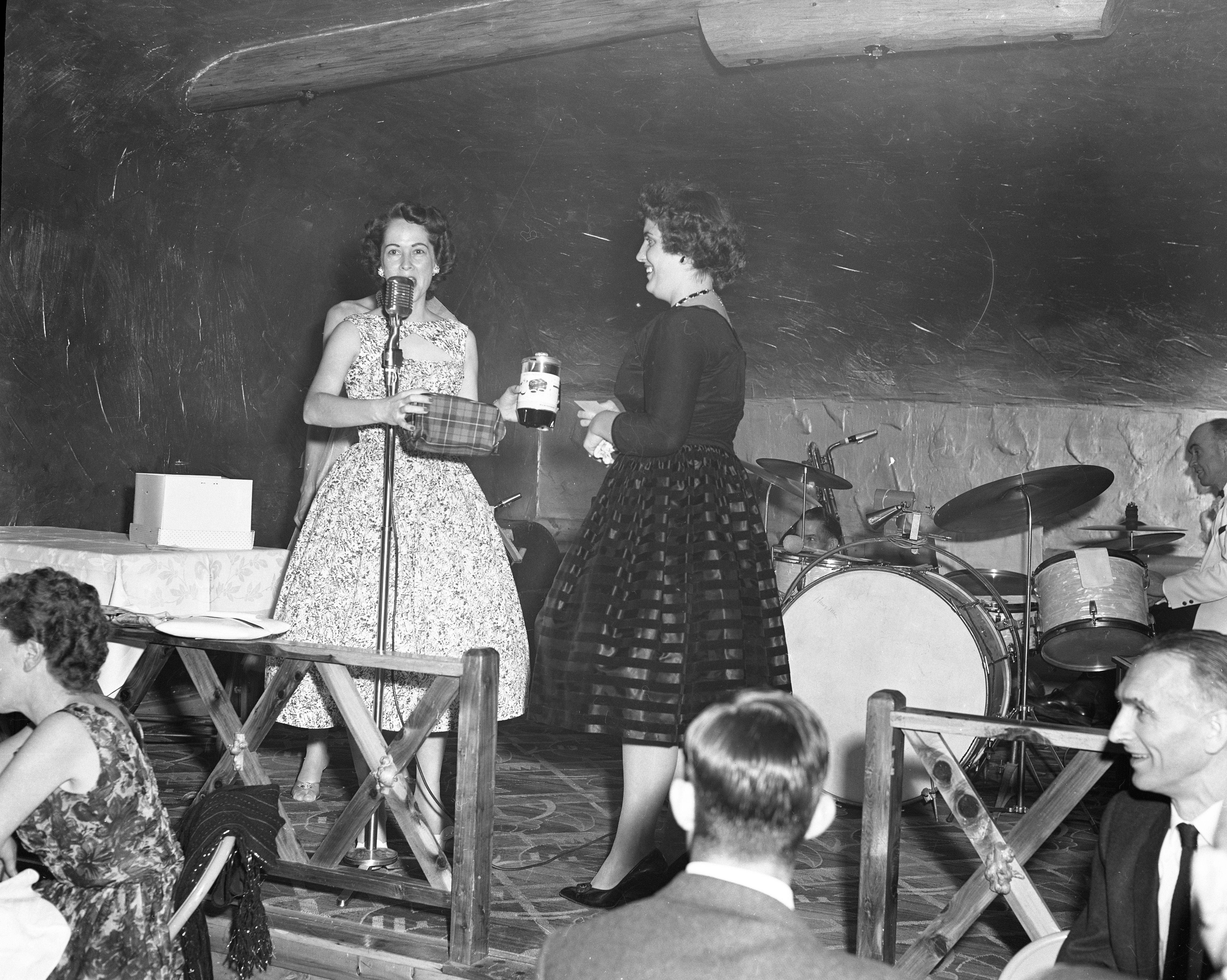 Women presenting gifts on stage at the Convair dance.