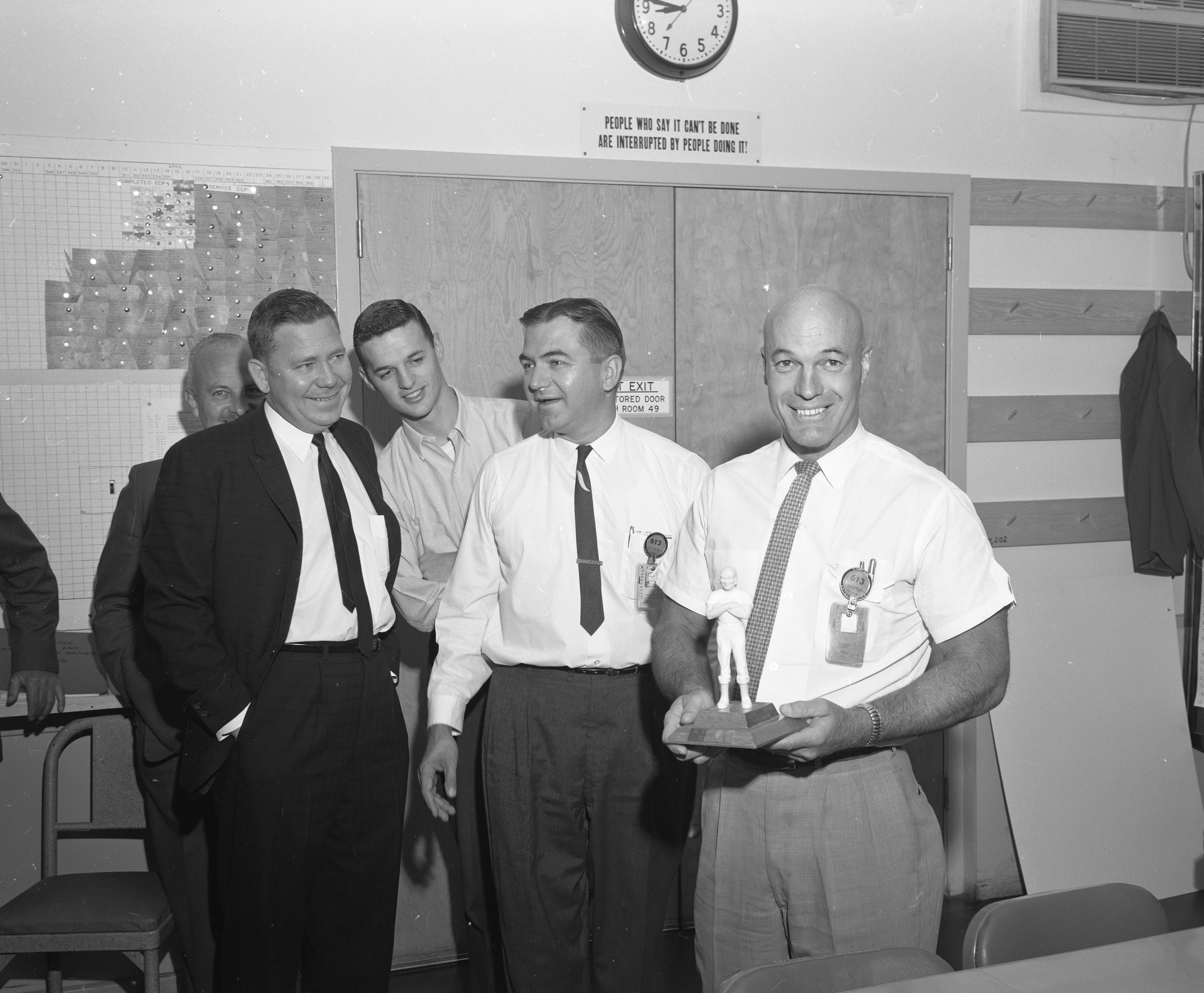 J. May and William F. Chana watching R. Franklin receive the Mr. Clean trophy on August 14th, 1961. 